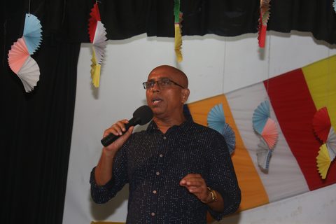 Ranjith Perera speaking into a microphone at a Light a Life event