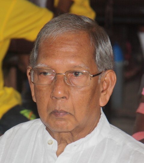 Portrait of Sarath Weerasooria wearing glasses and a white shirt