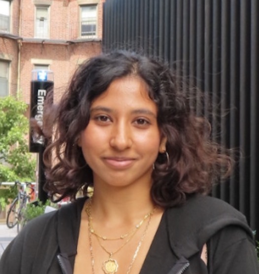 Portrait of Seheni Kariyawasan standing outdoors in a star-patterned jacket